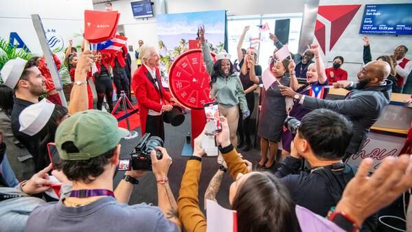 Sir Richard Branson surprises some Delta flyers in Atlanta with free vacation