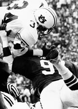 Auburn's Bo Jackson (34) dives over Alabama's Robbie Jones (97) for six points late in the fourth quarter of Saturday's SEC game in Birmingham, Ala., Nov. 29, 1982, to give the Tigers a one-point win over the Tide. It was the first time in 9 years that Alabama has lost the interstate championship. The score was 23-22. (AP Photo)